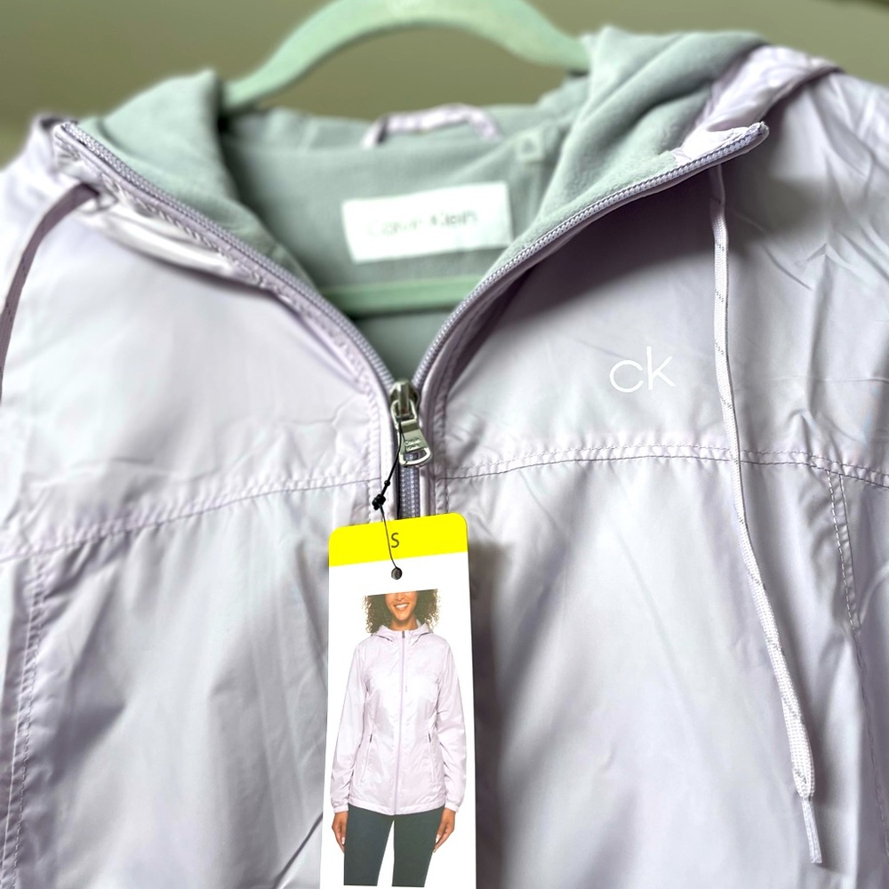 *NWT* Lt weight, lined, hooded CK windbreaker in lilac. Size small.